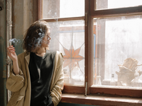 Woman smoking out the window
